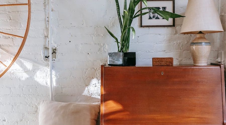 A cozy corner of a room with a yoga mat, a plant, and soft morning light.